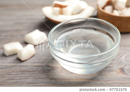 Coconut oil on wooden table, closeup view Coconut oil on wooden table, closeup view 97781876
