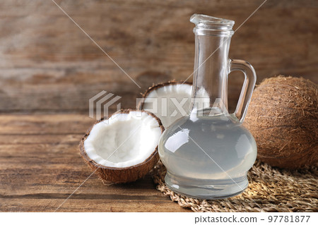 Composition with coconut oil on wooden table, space for text 97781877
