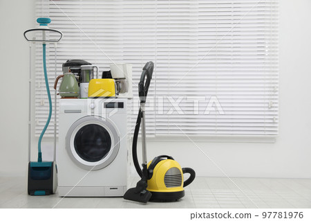Different household appliances near window in room. Space for text Different household appliances near window in room. Space for text 97781976