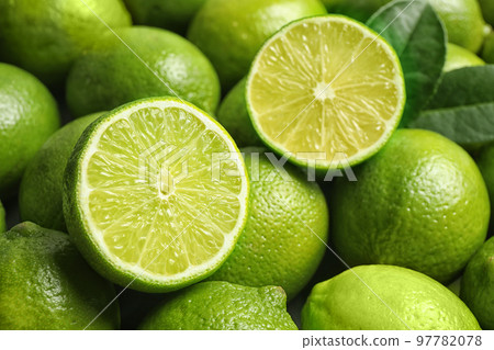 Fresh ripe juicy limes as background, closeup 97782078
