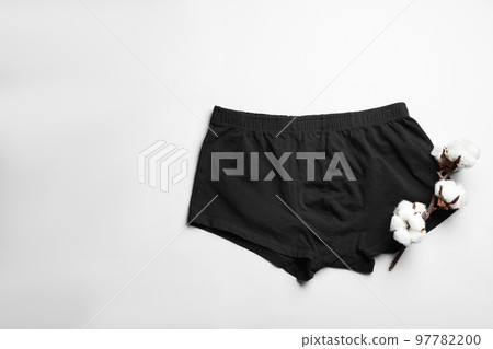 Comfortable men's underwear and cotton flowers on light background, top view Comfortable men's underwear and cotton flowers on light background, top view 97782200
