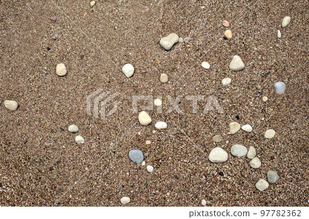 Clean sandy beach with multicolor stones of different shapes and sizes 97782362