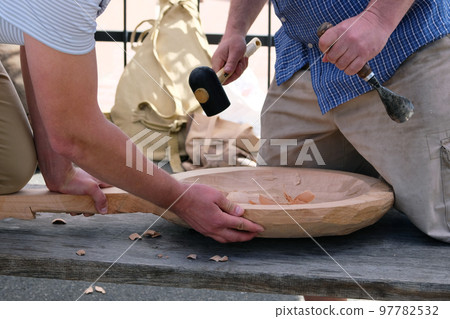 Wood carving. Two masters carve wood crafts product using woodworking tool, hands close up. Carpentry and craftsmanship concept 97782532