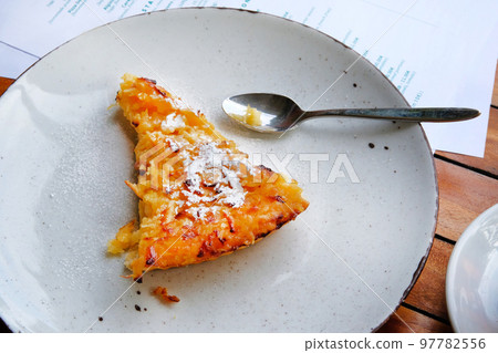 Slice of freshly baked apple open pie on porcelain plate, closeup 97782556