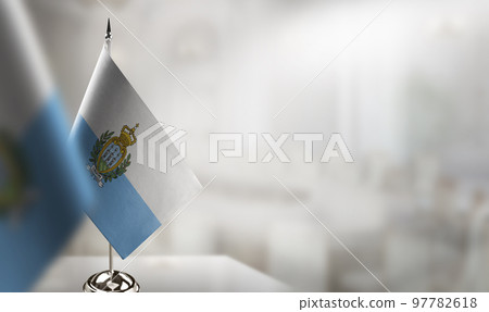 Small flags of the San Marino on an abstract blurry background Small flags of the San Marino on an abstract blurry background 97782618
