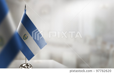 Small flags of the Salvador on an abstract blurry background Small flags of the Salvador on an abstract blurry background 97782620