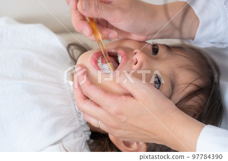 girl getting a toothbrush girl getting a toothbrush 97784390