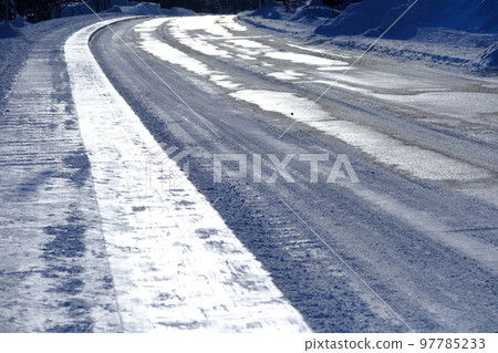 Asphalt road surface after snow removal 97785233