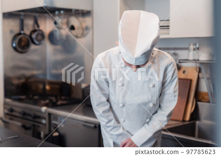 Male chef bowing Male chef bowing 97785623