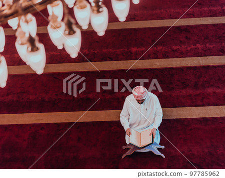 A Muslim reads the holy Islamic book Quraqn in a modern grand mosque during the Muslim holy month of Ranazan 97785962