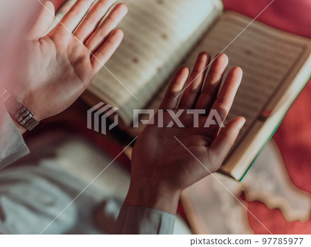 A Muslim reads the holy Islamic book Quraqn in a modern grand mosque during the Muslim holy month of Ranazan A Muslim reads the holy Islamic book Quraqn in a modern grand mosque during the Muslim holy month of Ranazan 97785977