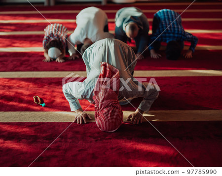 A group of Muslims in a modern mosque praying the Muslim prayer namaz, during the holy month of Ramadan A group of Muslims in a modern mosque praying the Muslim prayer namaz, during the holy month of Ramadan 97785990