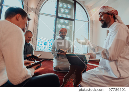 A group of Muslims reading the holy book of the Quran in a modern mosque during the Muslim holiday of Ramadan A group of Muslims reading the holy book of the Quran in a modern mosque during the Muslim holiday of Ramadan 97786301