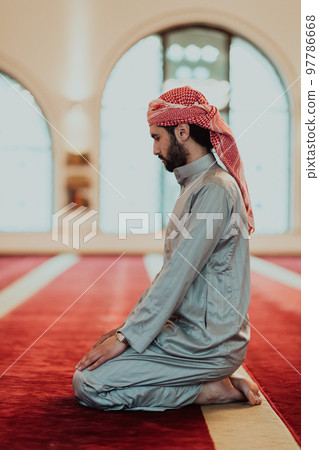 A Muslim praying in a modern mosque during the holy Muslim month of Ramadan 97786668
