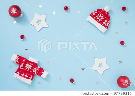 Christmas or winter frame with white and red decorations on pastel blue background. New year concept. 97789315