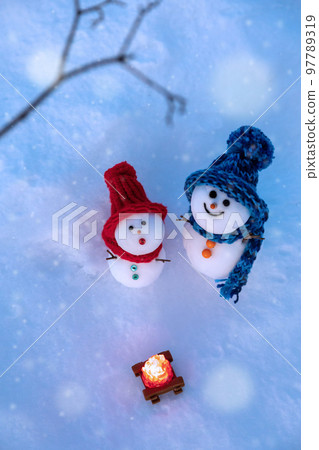 Snowmen looking up at the falling snow Snowmen looking up at the falling snow 97789319