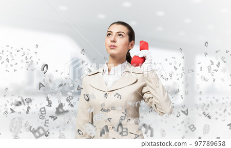 Attractive woman holding vintage red phone 97789658