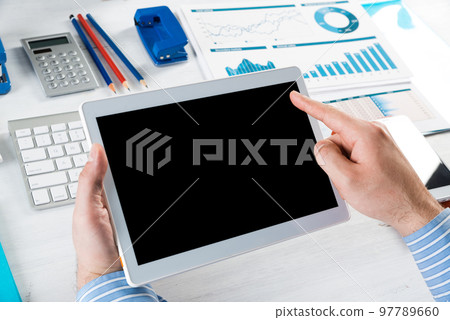 businessman with a tablet, works in the office 97789660