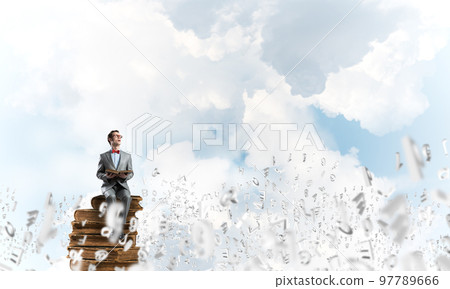Young businessman or student studying the science and symbols fly around 97789666