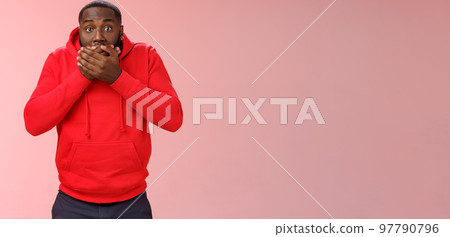 Shocked gasping surprised african-american guy overhear stunning rumour press palms mouth not slip word widen eyes impressed stunned unbeliavable amazing gossip, standing pink background 97790796