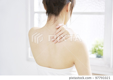 A woman doing back skin care Back view 97791021