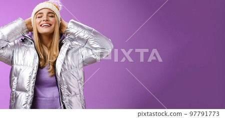 Carefree delighted young attractive blond woman enjoying fresh air winter forest breathing happily smiling feel freedom happiness hold hands behind close eyes grinning wearing warm jacket hat Carefree delighted young attractive blond woman enjoying fresh air winter forest breathing happily smiling feel freedom happiness hold hands behind close eyes grinning wearing warm jacket hat 97791773