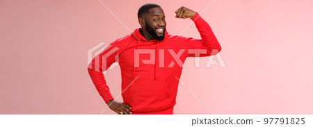Charming cheeky friendly african-american strong guy smiling broadly proudly showing biceps raise one hand bragging muscles attend gym recommend you get fit, standing pink background Charming cheeky friendly african-american strong guy smiling broadly proudly showing biceps raise one hand bragging muscles attend gym recommend you get fit, standing pink background 97791825