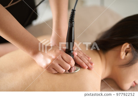 A woman undergoing treatment with a cavitation machine A woman undergoing treatment with a cavitation machine 97792252