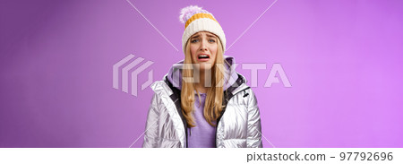 Upset sobbing miserable cute blond woman in silver stylish jacket hat crying whining unhappy feel sadness distress look disappointed complaining cruel life, unlucky standing purple background 97792696
