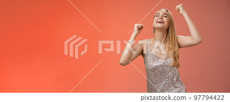 Excited carefree happy stylish blond european woman having fun dancing smiling broadly laughing happiness enjoying awesome music party rocking lighting dance-floor standing red background Excited carefree happy stylish blond european woman having fun dancing smiling broadly laughing happiness enjoying awesome music party rocking lighting dance-floor standing red background 97794422