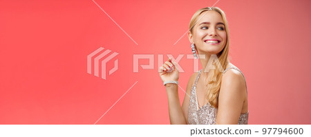 Elegant glamour gorgeous young rich blond woman attend charity party in stylish silver glittering dress accessorize turning right smiling greeting familiar person grinning joyfully, red background Elegant glamour gorgeous young rich blond woman attend charity party in stylish silver glittering dress accessorize turning right smiling greeting familiar person grinning joyfully, red background 97794600