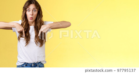 You see that too. Surprised wondered amazed happy astonished funny cheerful girl long curly haircut stare impressed amazed pointing down react fascinated curious bottom promo yellow background You see that too. Surprised wondered amazed happy astonished funny cheerful girl long curly haircut stare impressed amazed pointing down react fascinated curious bottom promo yellow background 97795137