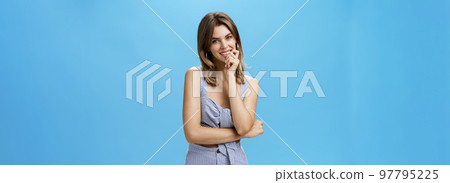 Portrait of charming attractive young woman in trendy matching clothes smiling sensually as if having thought in mind showing cute diastema while grinning posing over blue background Portrait of charming attractive young woman in trendy matching clothes smiling sensually as if having thought in mind showing cute diastema while grinning posing over blue background 97795225