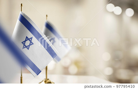 Small flags of the Israel on an abstract blurry background Small flags of the Israel on an abstract blurry background 97795410