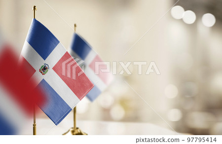 Small flags of the Dominicana on an abstract blurry background 97795414