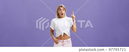 I have got idea. Thrilled and excited attractive stylish feminine woman with tattoos popping eyes folding lips, gasping raising index finger up in eureka gesture having excellent idea over purple wall I have got idea. Thrilled and excited attractive stylish feminine woman with tattoos popping eyes folding lips, gasping raising index finger up in eureka gesture having excellent idea over purple wall 97795721
