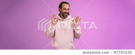 Devious tricky good-looking happy mature man 50s bearded grey hair show okay excellent perfection gesture smug smirking mysterious have everything under control, assuring all fine, purple background 97795830