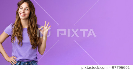 Confident professional girl not scared difficult task assure everything okay smiling broadly self-assured pose hold hand hip show ok ring sign grinning accepting agree good terms purple background 97796601