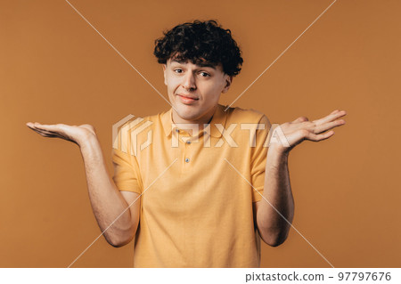 Confused man, shoulders up - can't help, makes gesture of I dont know. Difficult question, guilty 97797676