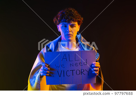 Ukrainian man with cardboard All we need is victory. Ukraine will win war. Protest, democracy 97797688