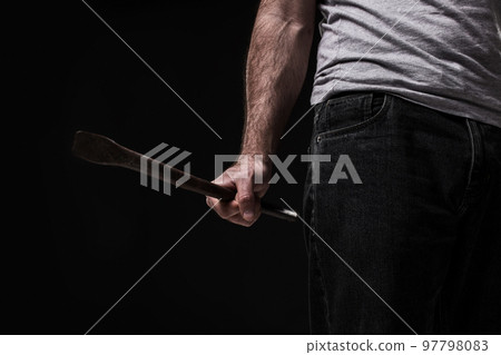 Male offender with a scrap. On black background at the studio Male offender with a scrap. On black background at the studio 97798083