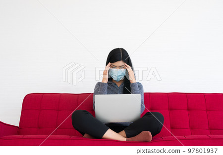 Tired woman wearing a face mask, Headaches and migraines, the suffering of office syndrome after long hours work on the computer. Office syndrome and Health care concept. Tired woman wearing a face mask, Headaches and migraines, the suffering of office syndrome after long hours work on the computer. Office syndrome and Health care concept. 97801937