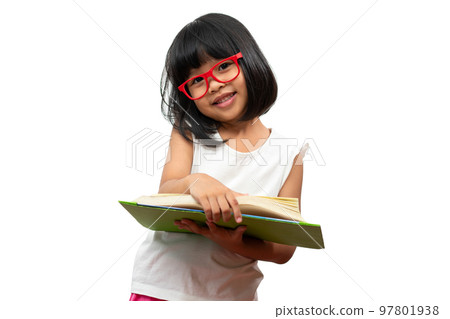 Happy Asian little preschool girl wearing red glasses holding and read a green book on white isolated background. Concept of school kid and education in elementary and preschool, home school Happy Asian little preschool girl wearing red glasses holding and read a green book on white isolated background. Concept of school kid and education in elementary and preschool, home school 97801938
