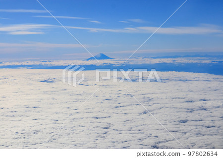 Fuji above the clouds seen from the plane Fuji above the clouds seen from the plane 97802634