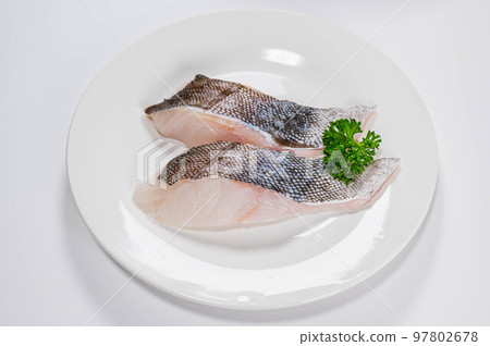 Cod fillet on a white plate 97802678