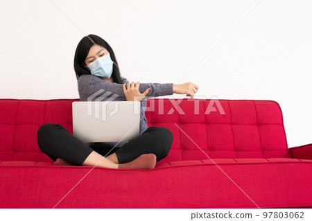 Tired woman wearing a face mask, pain in neck tensed muscles and stretch, the suffering of office syndrome after long hours work on the computer. Office syndrome and Health care concept. Tired woman wearing a face mask, pain in neck tensed muscles and stretch, the suffering of office syndrome after long hours work on the computer. Office syndrome and Health care concept. 97803062