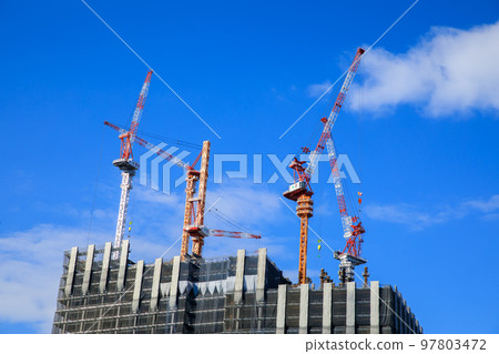 Tower crane building a skyscraper 97803472