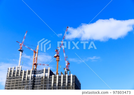Tower crane building a skyscraper Tower crane building a skyscraper 97803473