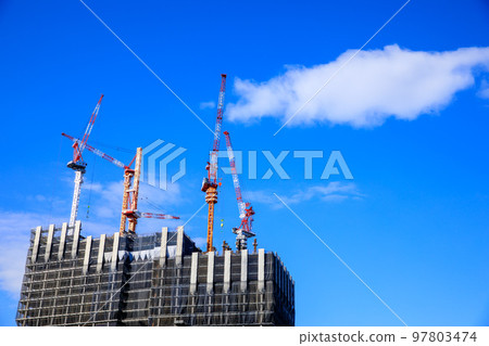 Tower crane building a skyscraper Tower crane building a skyscraper 97803474