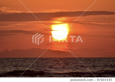 Winter beach at dusk with sun pillar F Winter beach at dusk with sun pillar F 97803545